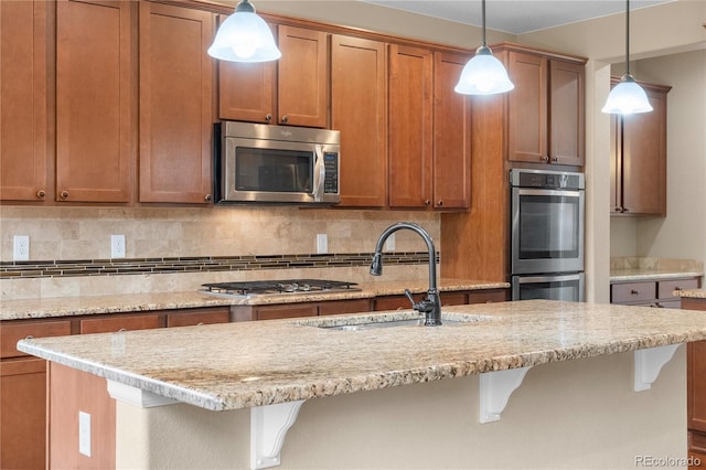 3995 Manorbrier Cir, Castle Rock, CO 80104 - kitchen featuring stainless steel appliances, a sink, tasteful backsplash, a breakfast bar, and light stone counters