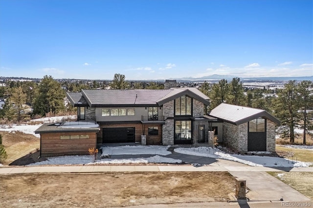 view of front facade with a mountain view and a garage