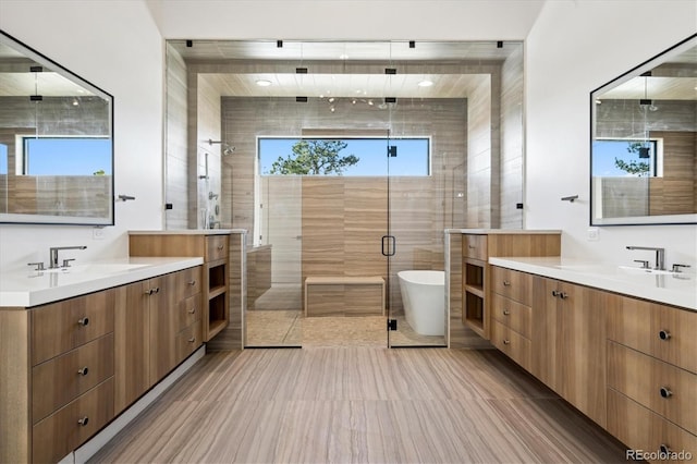 bathroom with vanity, hardwood / wood-style flooring, separate shower and tub, and tile walls