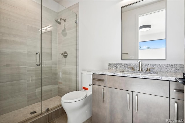 bathroom with vanity, toilet, and an enclosed shower