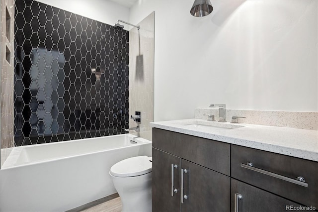 full bathroom featuring hardwood / wood-style floors, vanity, toilet, and tiled shower / bath combo