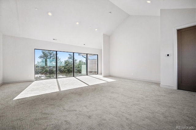 unfurnished living room featuring high vaulted ceiling and light colored carpet