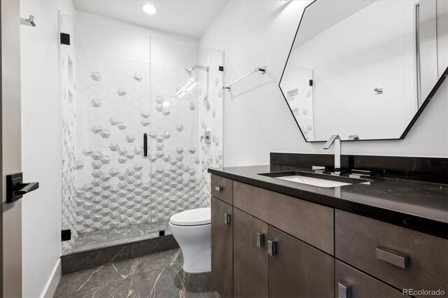 bathroom with vanity, toilet, and an enclosed shower