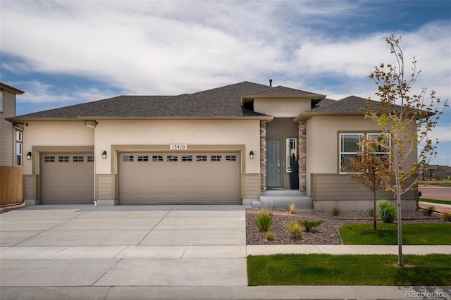 13410 New Ranch Dr, Peyton, CO 80831 - prairie-style home with a garage, concrete driveway, stucco siding, and stone siding
