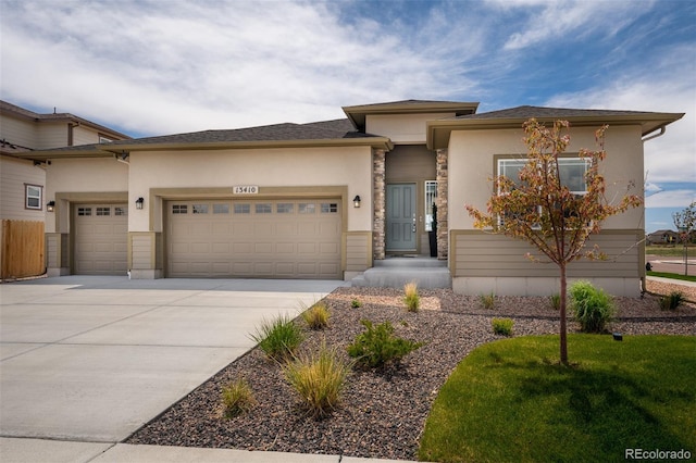 13410 New Ranch Dr, Peyton, CO 80831 - prairie-style home featuring a garage, stucco siding, concrete driveway, and stone siding