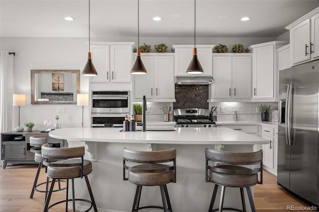 13410 New Ranch Dr, Peyton, CO 80831 - kitchen with stainless steel appliances, light wood-style floors, backsplash, white cabinets, and recessed lighting