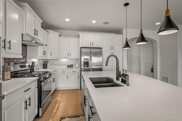 13410 New Ranch Dr, Peyton, CO 80831 - kitchen featuring stainless steel appliances, a sink, under cabinet range hood, light countertops, and white cabinets