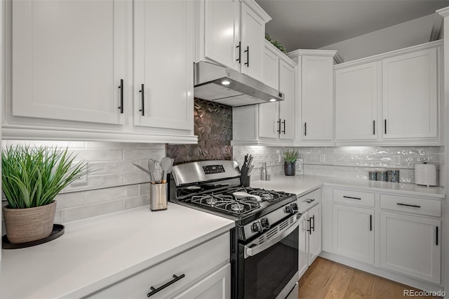 13410 New Ranch Dr, Peyton, CO 80831 - kitchen featuring stainless steel range with gas cooktop, under cabinet range hood, white cabinets, and light countertops