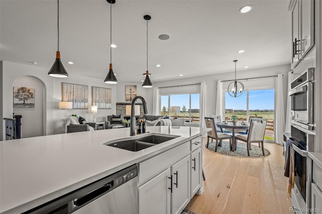 13410 New Ranch Dr, Peyton, CO 80831 - kitchen with a sink, open floor plan, recessed lighting, light wood-type flooring, and light countertops