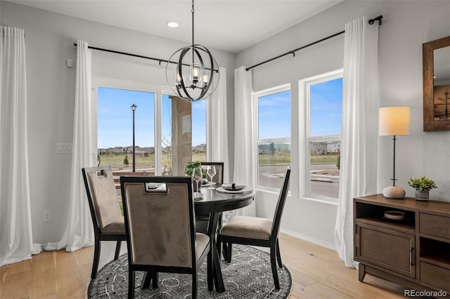 13410 New Ranch Dr, Peyton, CO 80831 - dining area featuring a chandelier, light wood finished floors, recessed lighting, and baseboards