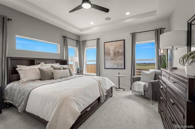 13410 New Ranch Dr, Peyton, CO 80831 - bedroom with light carpet, a tray ceiling, recessed lighting, ceiling fan, and baseboards
