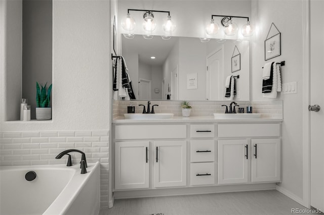13410 New Ranch Dr, Peyton, CO 80831 - bathroom featuring double vanity, a bath, and tasteful backsplash