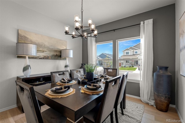 13410 New Ranch Dr, Peyton, CO 80831 - dining space with light wood-style floors, a chandelier, and baseboards