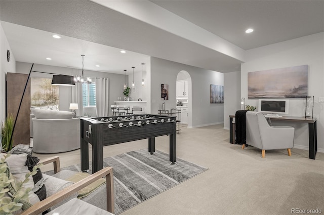 13410 New Ranch Dr, Peyton, CO 80831 - recreation room featuring light carpet, baseboards, arched walkways, recessed lighting, and a chandelier