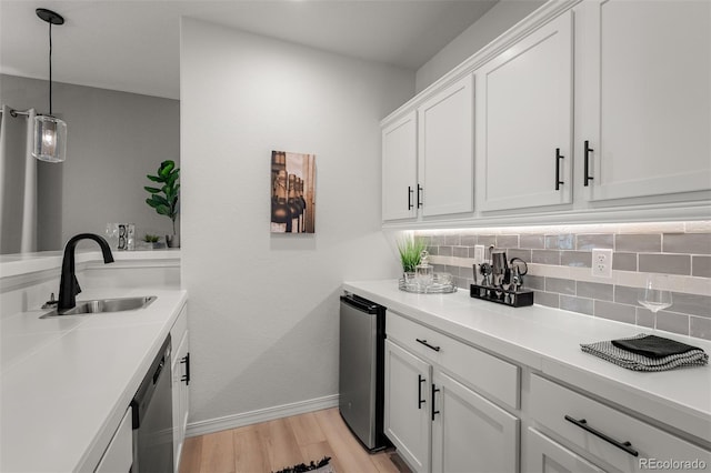 13410 New Ranch Dr, Peyton, CO 80831 - laundry room featuring a sink, baseboards, and light wood-style flooring