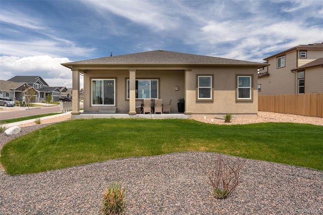 13410 New Ranch Dr, Peyton, CO 80831 - back of property with stucco siding and a patio