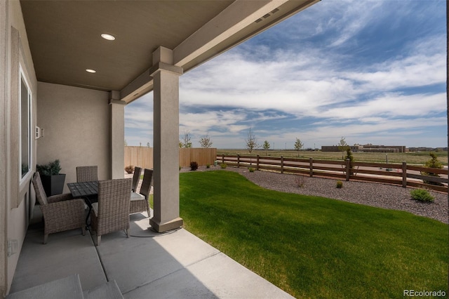 13410 New Ranch Dr, Peyton, CO 80831 - view of patio featuring outdoor dining area and a view of countryside