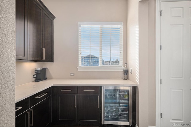 kitchen with dark brown cabinetry and beverage cooler