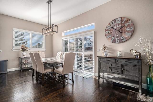 dining space with dark hardwood / wood-style flooring