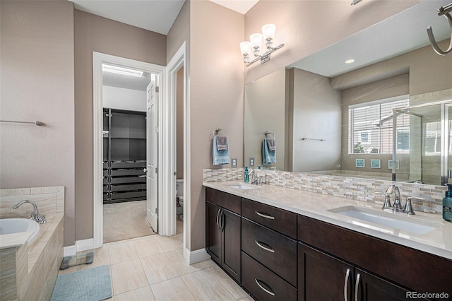 full bathroom with vanity, toilet, separate shower and tub, and decorative backsplash