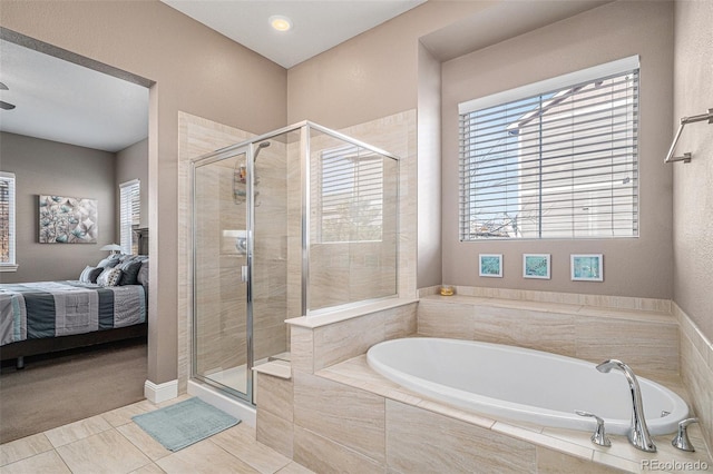 bathroom with tile patterned floors and separate shower and tub