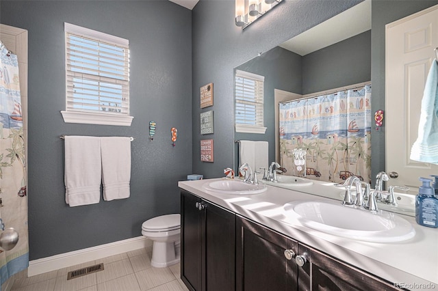 bathroom featuring a shower with shower curtain, vanity, toilet, and tile patterned flooring