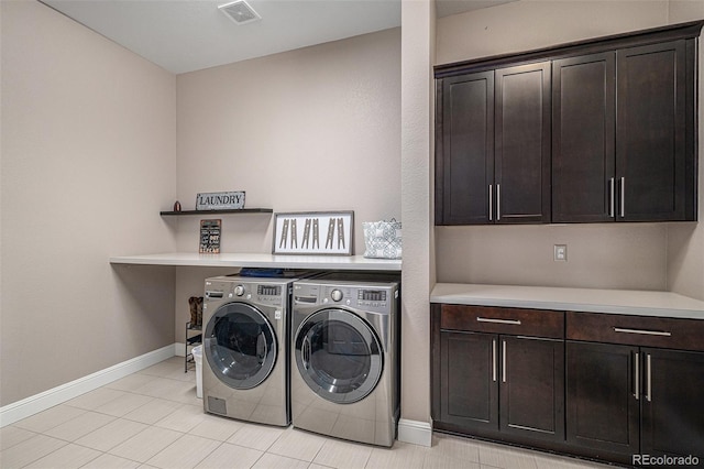 washroom featuring cabinets and washer and dryer