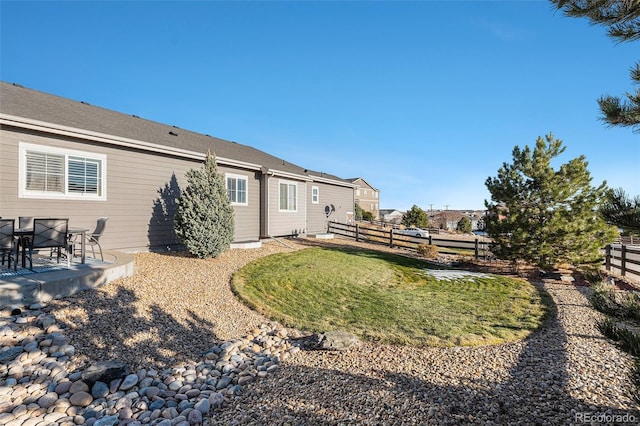 rear view of house featuring a lawn and a patio area