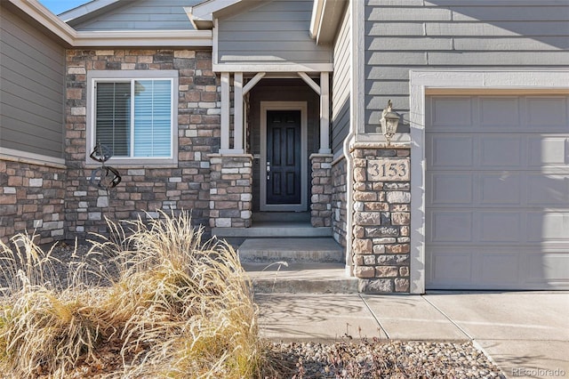 view of exterior entry with a garage