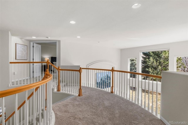 hall with an upstairs landing, recessed lighting, and carpet