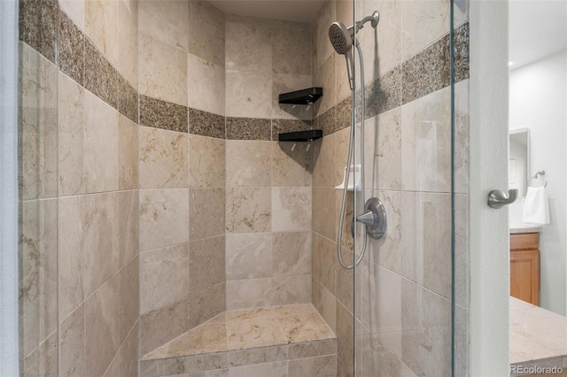 bathroom featuring vanity and a tile shower