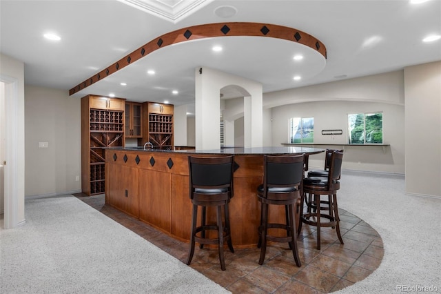 bar with recessed lighting, baseboards, and indoor bar