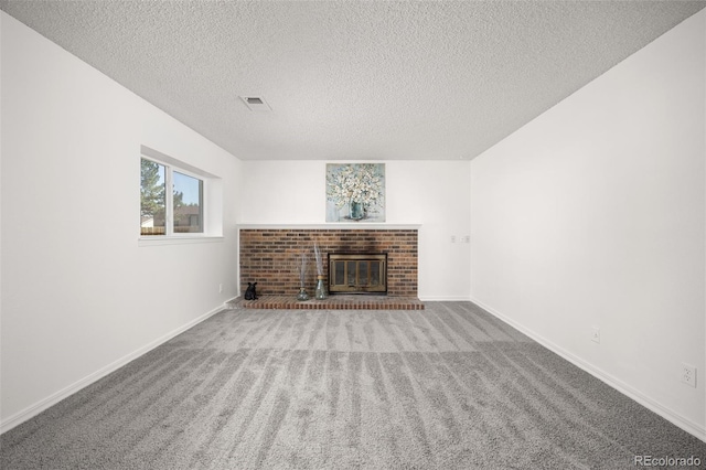 18527 E Kansas Pl, Aurora, CO 80017 - unfurnished living room featuring carpet flooring, a brick fireplace, and a textured ceiling