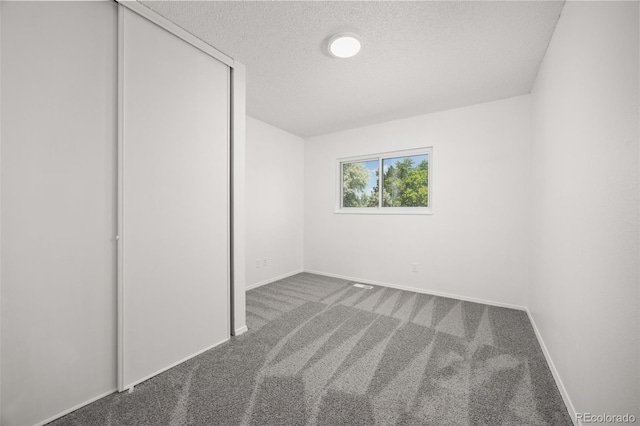18527 E Kansas Pl, Aurora, CO 80017 - unfurnished bedroom featuring a textured ceiling, carpet floors, and a closet