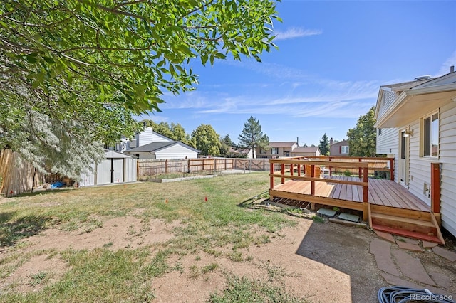 18527 E Kansas Pl, Aurora, CO 80017 - fenced backyard featuring a storage shed and a wooden deck