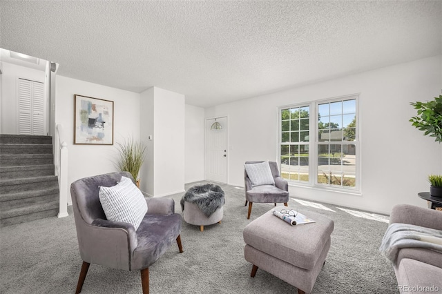 18527 E Kansas Pl, Aurora, CO 80017 - carpeted living room with stairs and a textured ceiling