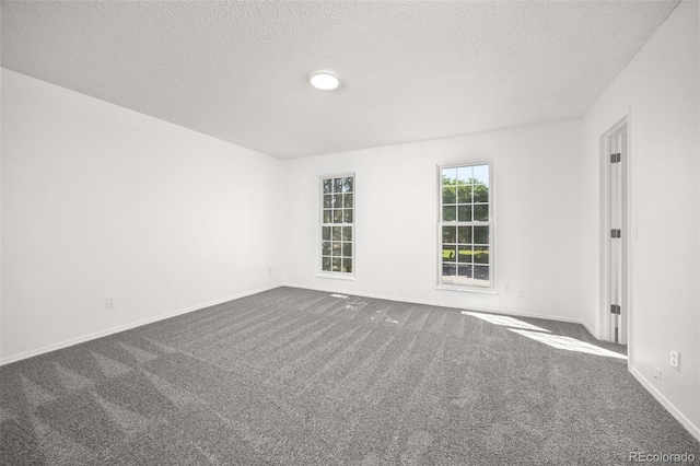 18527 E Kansas Pl, Aurora, CO 80017 - spare room featuring dark colored carpet and a textured ceiling