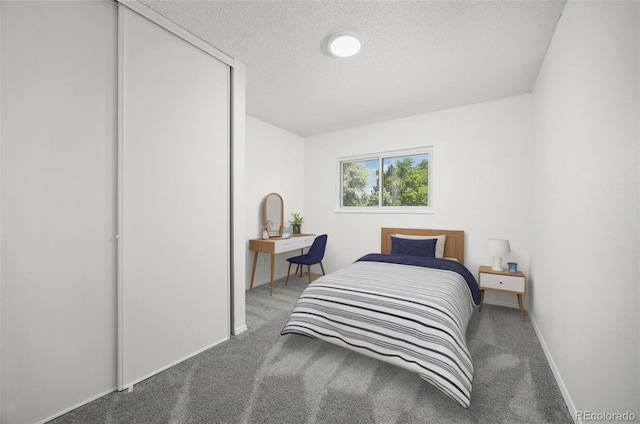 18527 E Kansas Pl, Aurora, CO 80017 - carpeted bedroom with a textured ceiling and baseboards