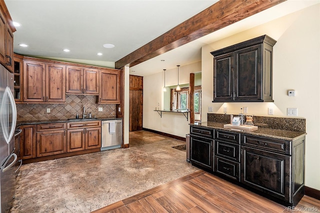 kitchen featuring beamed ceiling, a sink, tasteful backsplash, appliances with stainless steel finishes, and baseboards