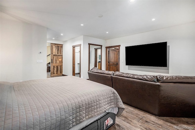 bedroom with recessed lighting and wood finished floors