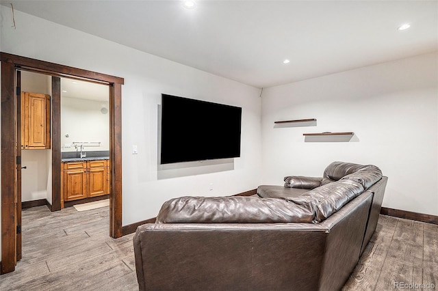 living room featuring recessed lighting, light wood-type flooring, and baseboards