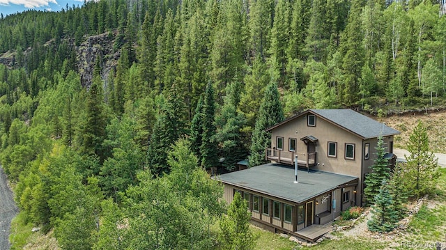 drone / aerial view with a wooded view