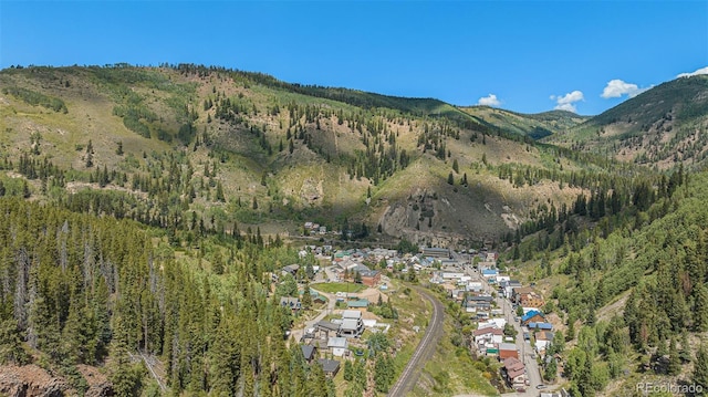 aerial view with a mountain view and a wooded view