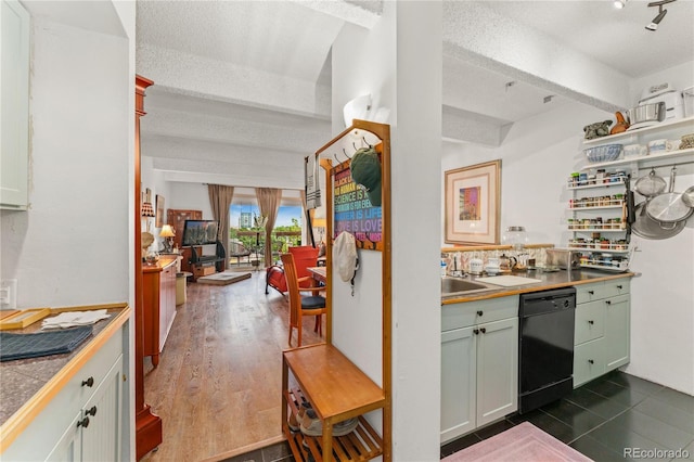 kitchen featuring beam ceiling, dark tile patterned floors, a textured ceiling, tile counters, and black dishwasher