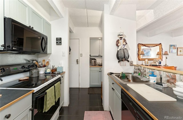 kitchen with dark tile patterned flooring, sink, a textured ceiling, and black appliances