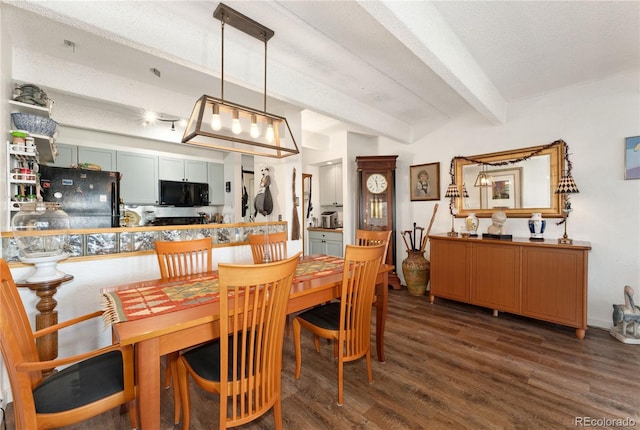 dining space with a textured ceiling, dark wood-type flooring, and beamed ceiling