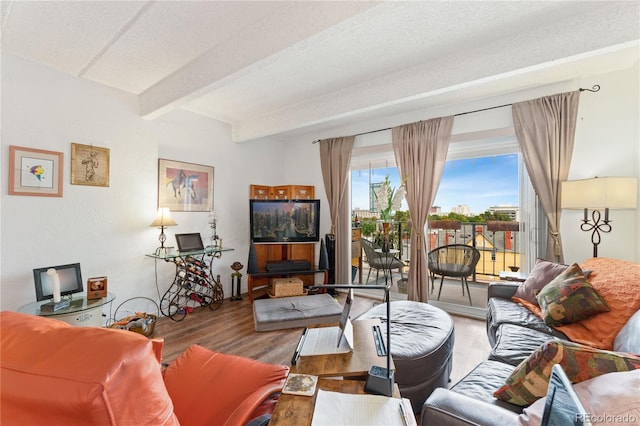 living room featuring a textured ceiling, beam ceiling, and hardwood / wood-style floors