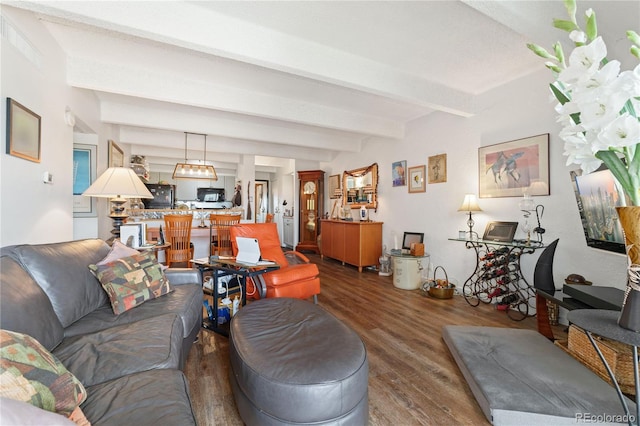 living room featuring beamed ceiling and dark hardwood / wood-style flooring