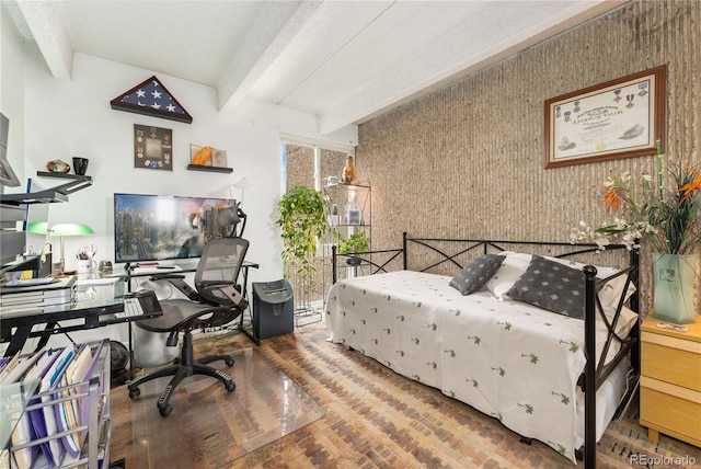 bedroom with a textured ceiling and beamed ceiling