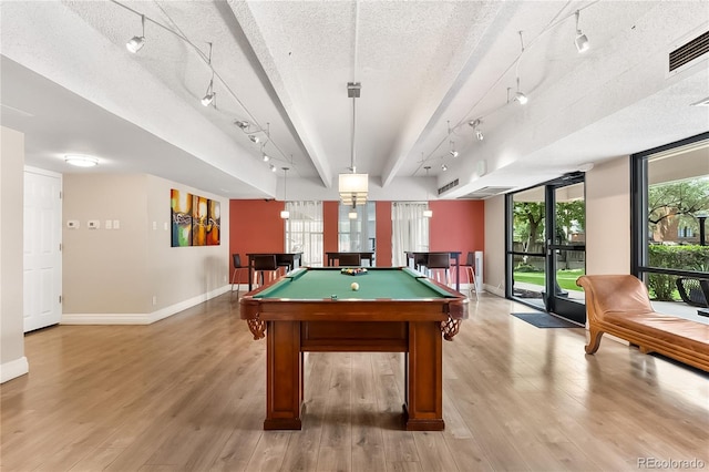 rec room featuring a textured ceiling, light hardwood / wood-style flooring, rail lighting, and pool table